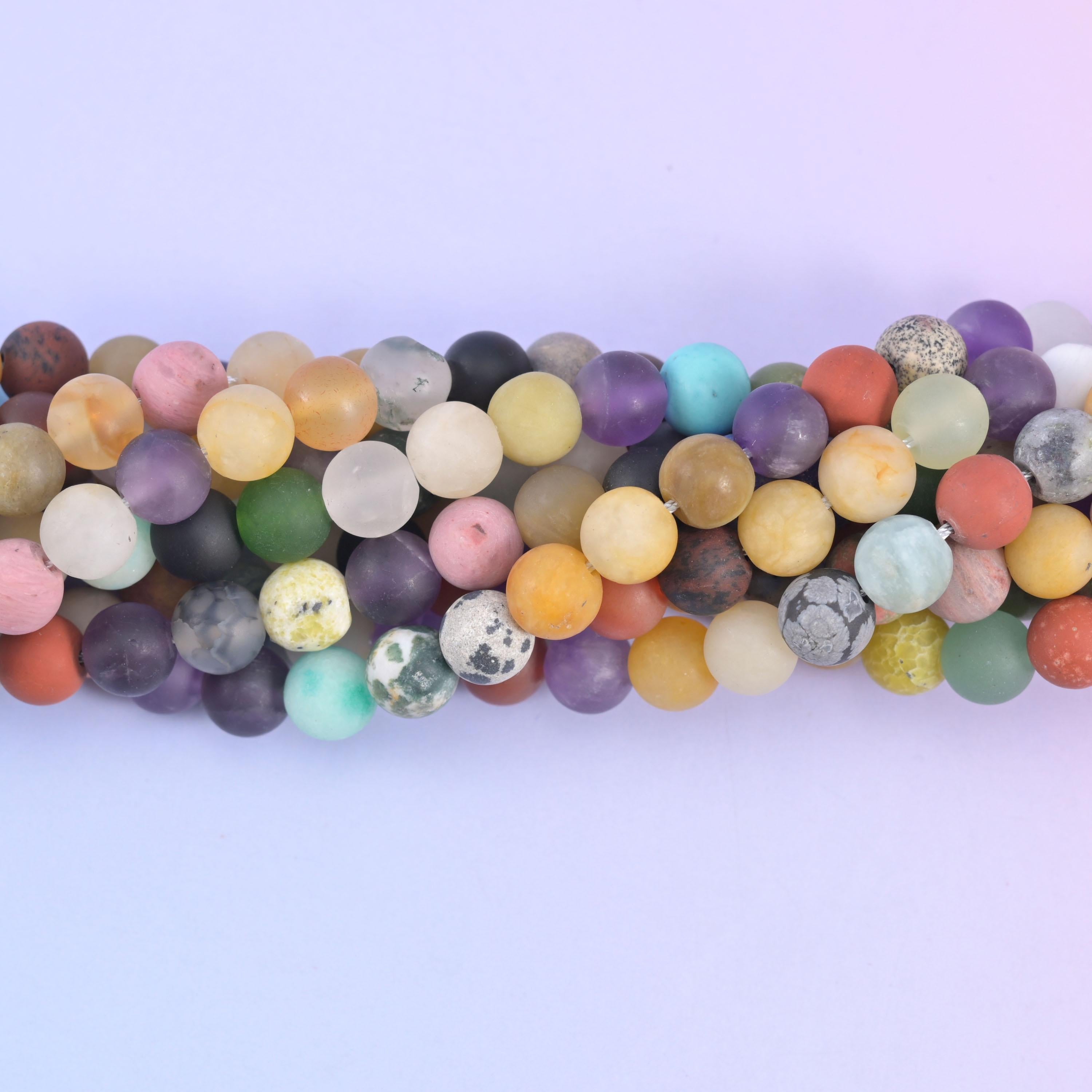 Close view of frosted matte rounds in turquoise, coral, mustard and sage