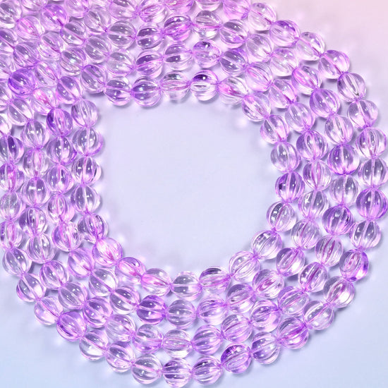 Clear purple pumpkin glass beads coiled into a wide open ring, the fluted grooves catching the light.