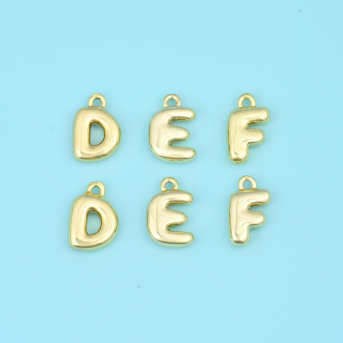 18K gold plated letter pendants D, E and F, rounded balloon initials each with a small bail loop at the top.
