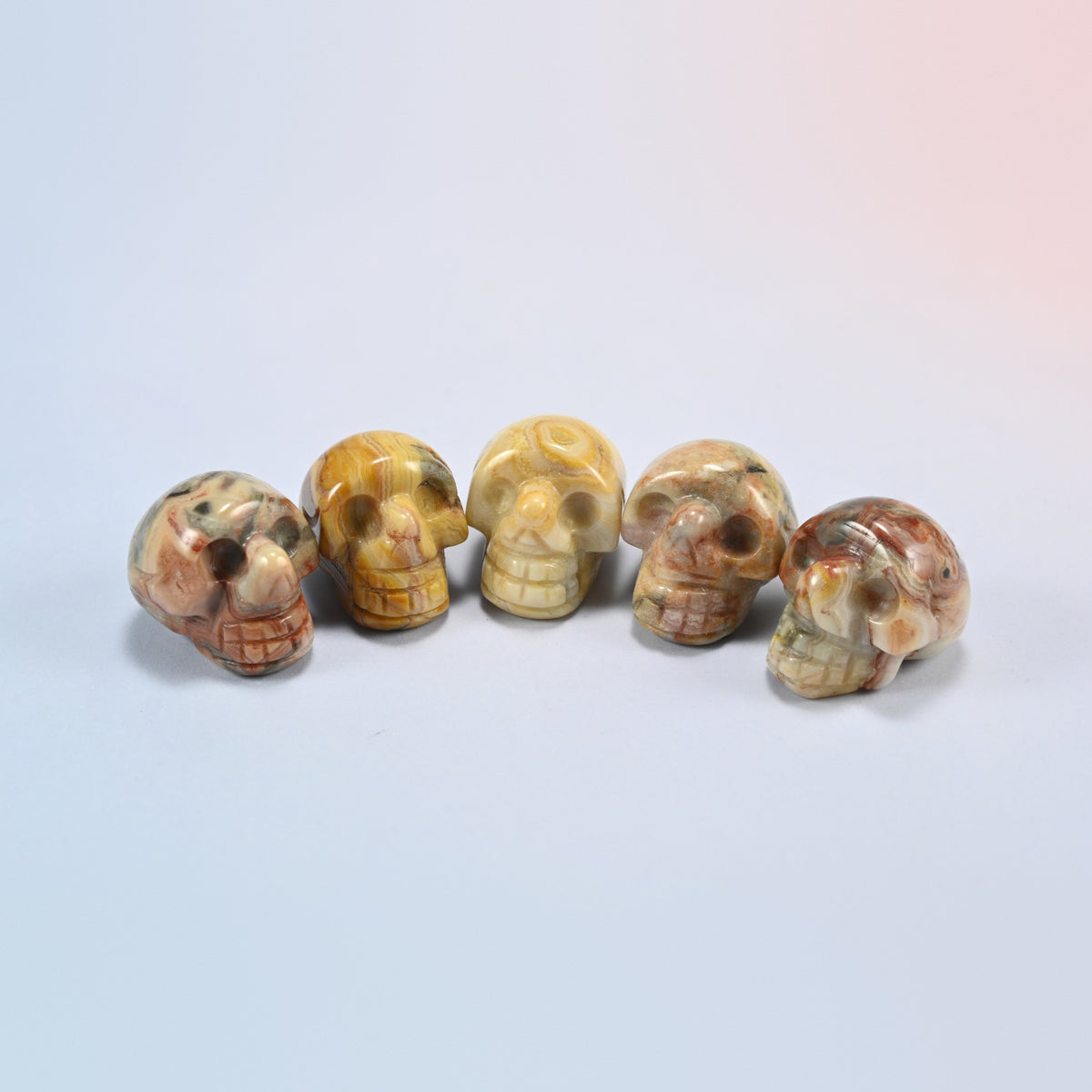 1 inch skull crystal carving in crazy agate, cream and golden natural stone with lace patterns