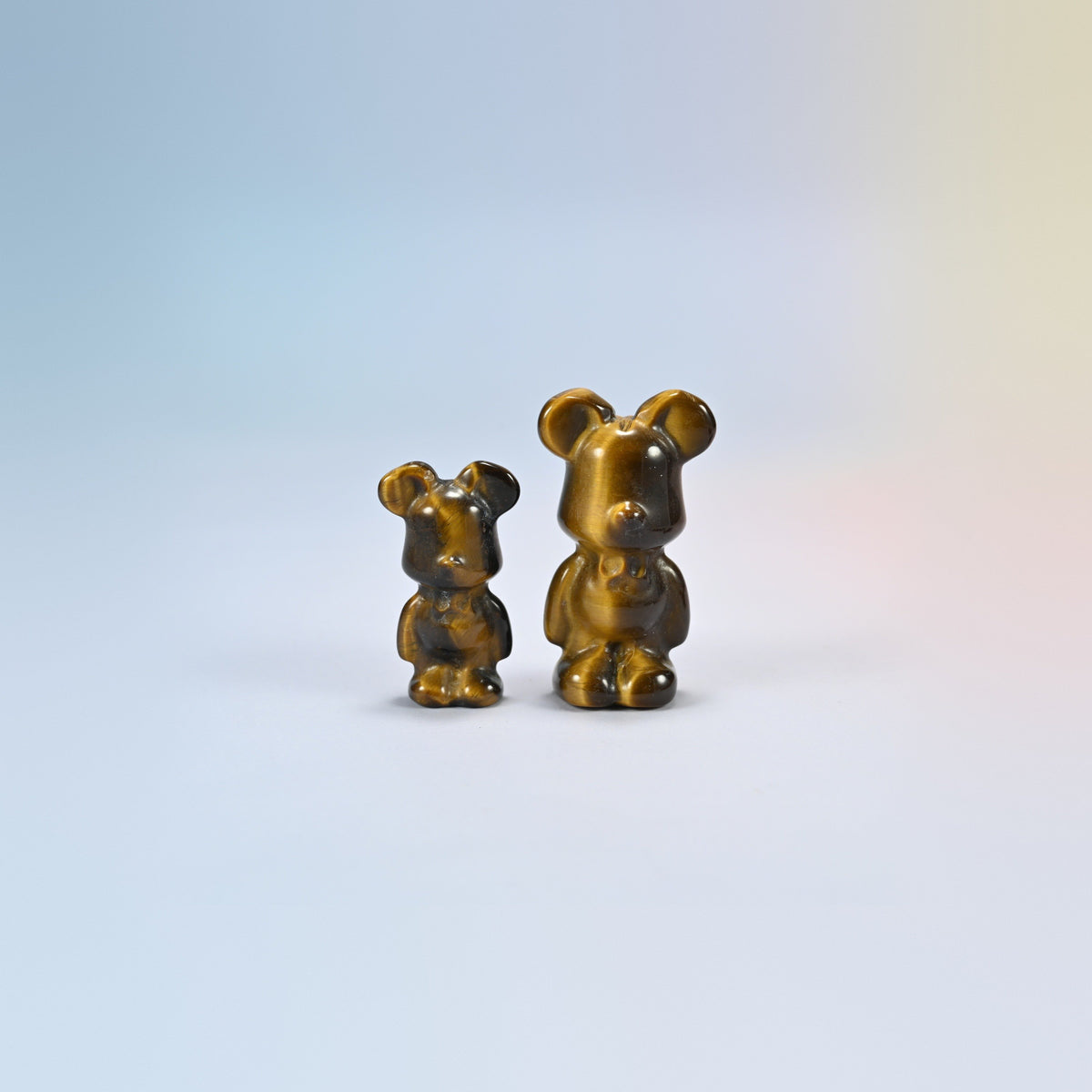 A 1.5 inch and a 2 inch tiger eye power bear crystal carving, golden brown natural stone with shimmering bands