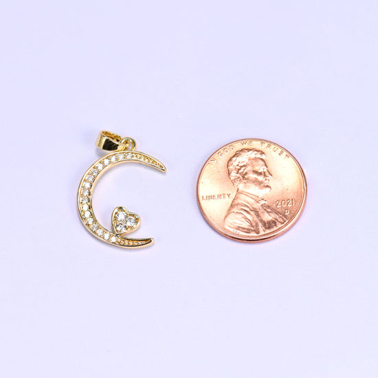 Moon heart zirconia charm scale shot, the gold crescent pendant photographed next to a US penny.