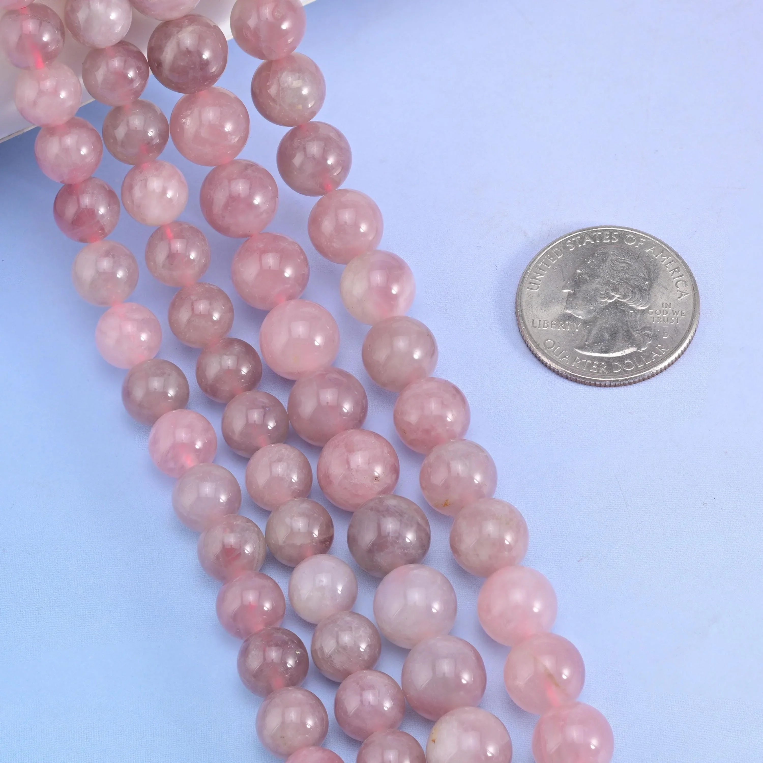 Smooth round cut Madagascar Rose Quartz beads for jewelry making.
