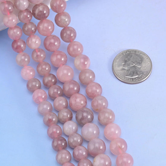 Smooth round cut Madagascar Rose Quartz beads for jewelry making.