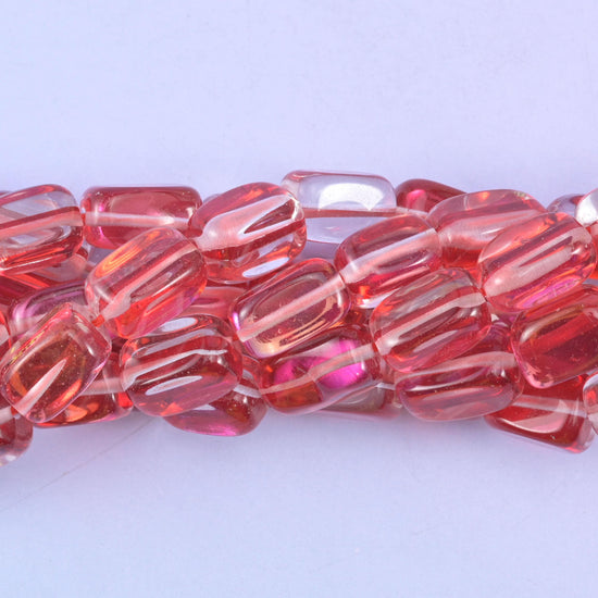 Rectangular cut glass beads with a glossy transparent finish and iridescent mystic aura coating
