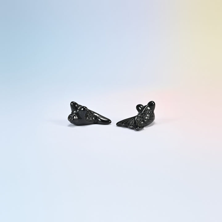 Two 1.5 inch natural black obsidian goldfish carvings, glossy black with a fan tail