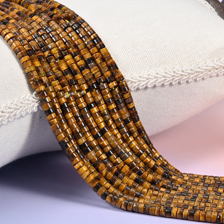 Natural Tiger Eye smooth heishi disc beads in warm golden brown with a signature chatoyant shimmer