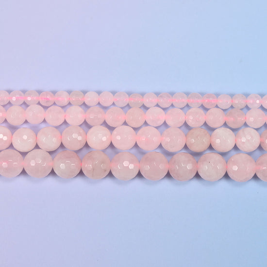 Full 15-inch strand of pink rose quartz round beads laid out for jewelry making.