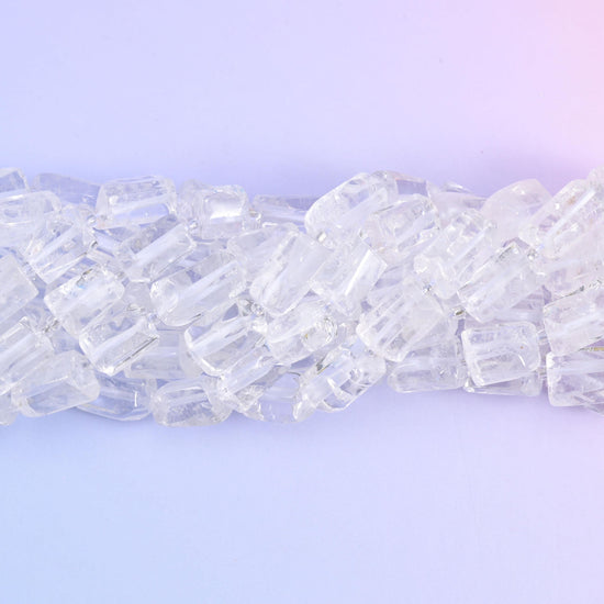 Strands lying in a shallow S, frosted fracture lines catching light inside otherwise glassy beads