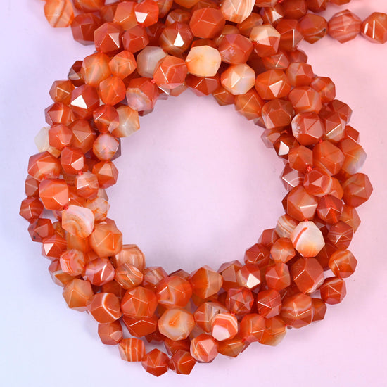 Dyed Red Stripe Agate star cut beads coiled in a loop, approximately 38 beads per 10mm strand