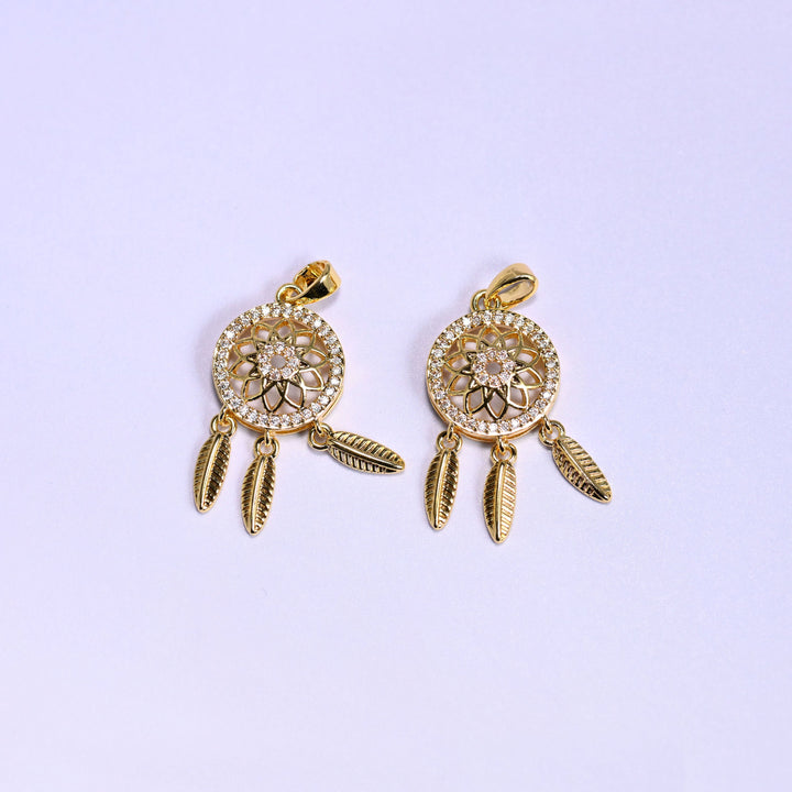 Two gold Dream Catcher Zirconia Charms side by side, 18K gold plated medallions set with clear zirconia pave and hung with feather dangles.