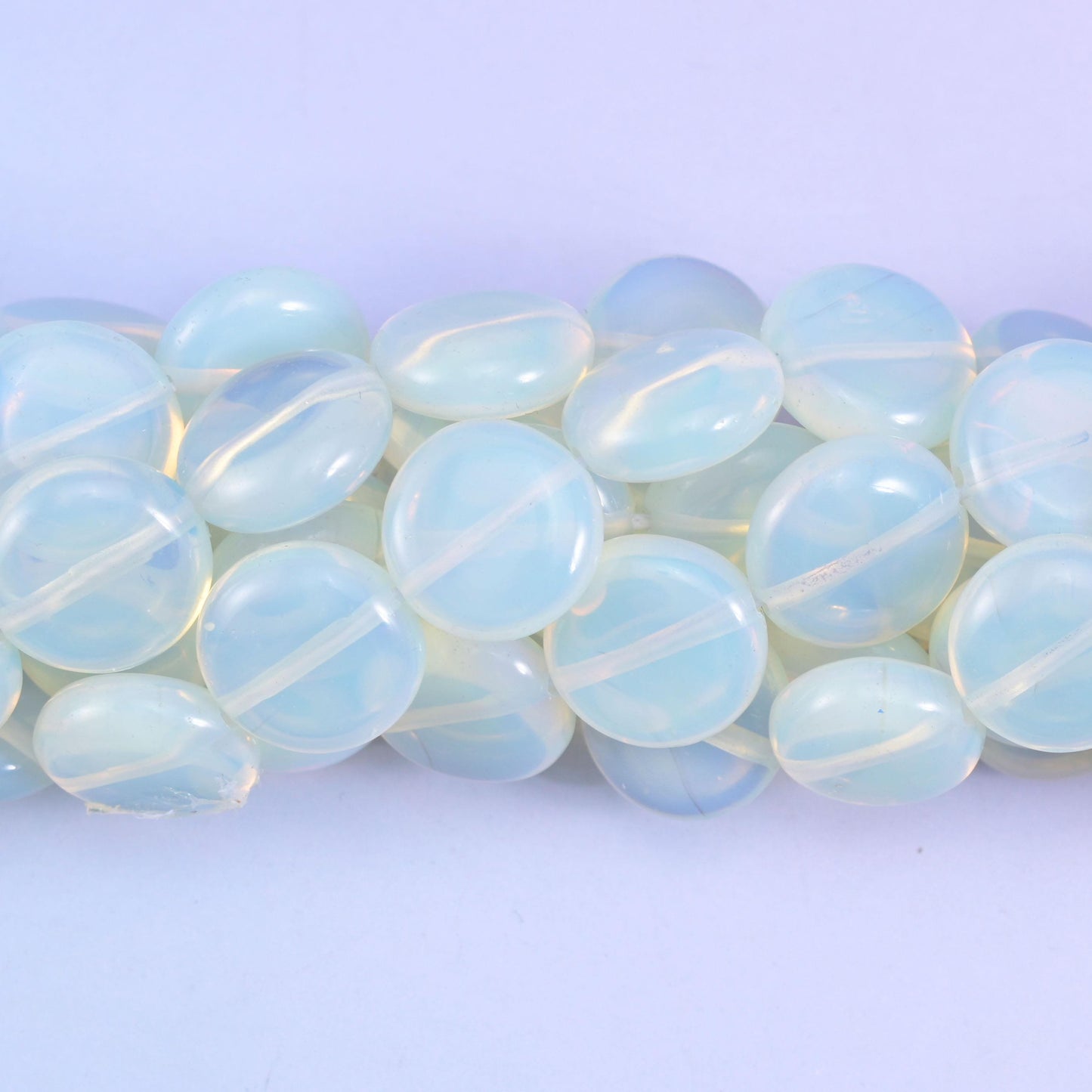 Coin cut Opalite glass beads with a high glassy polish