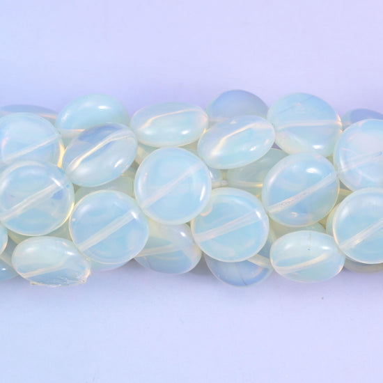 Coin cut Opalite glass beads with a high glassy polish