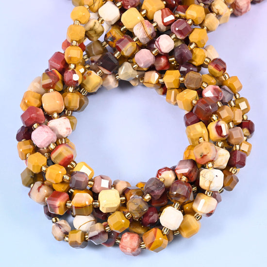 Mustard yellow, warm ochre, deep burgundy, dusty rose and cream cubes, many carrying two or three of those colours at once, each corner faceted.