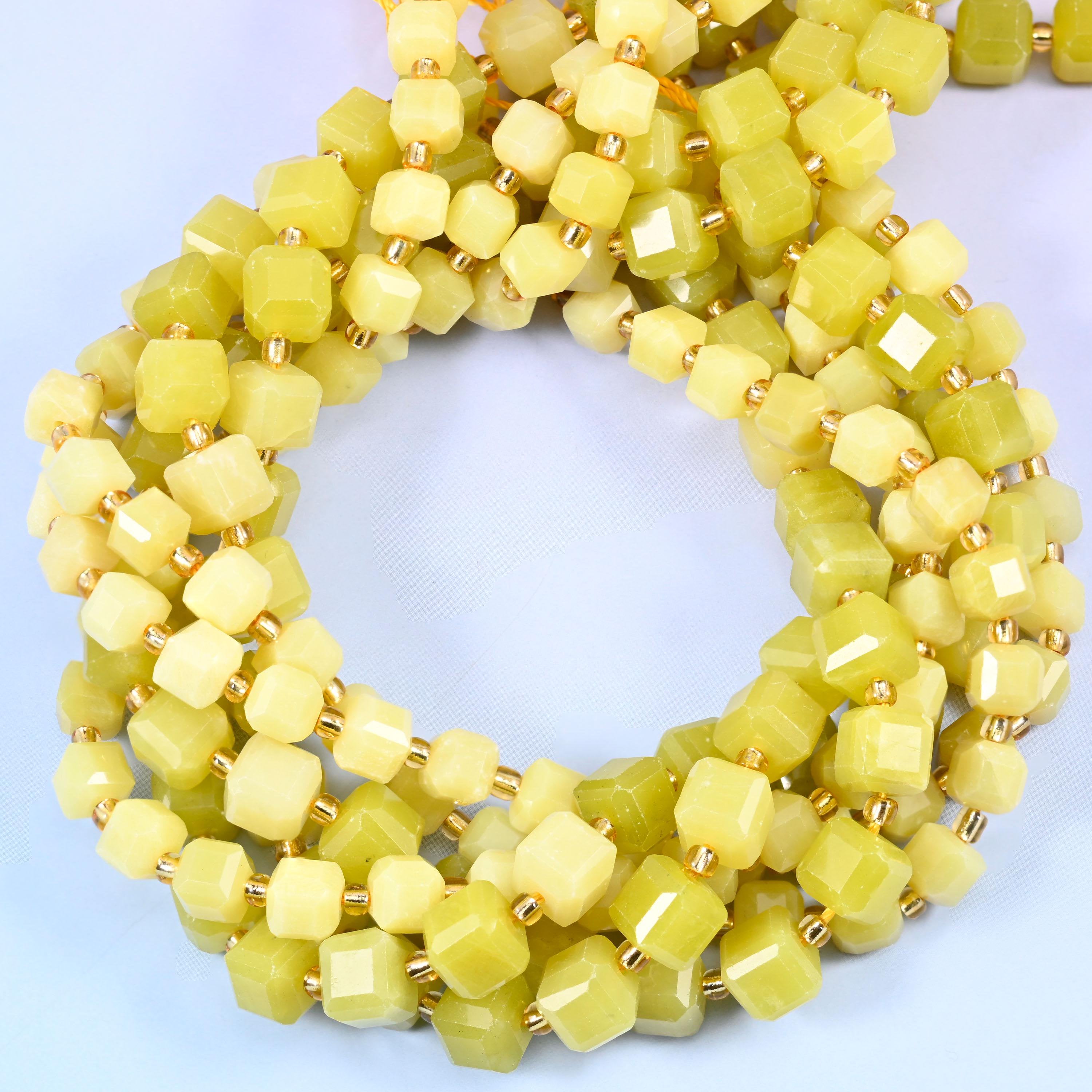 Soft lemon-yellow cubes drifting into olive and pale cream, semi-translucent with a waxy sheen, faceted at the corners so the yellow lifts on every flat face.