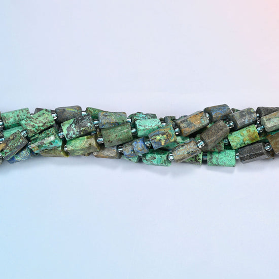 Strands of azurite chrysocolla faceted tube beads twisted together in a horizontal row