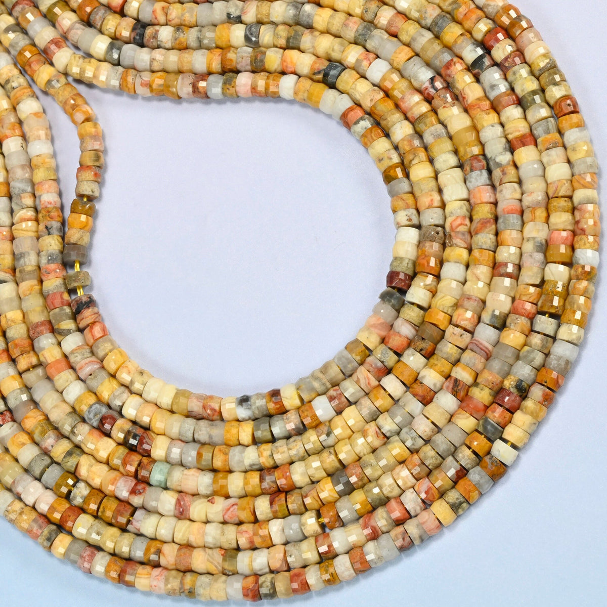 Crazy agate faceted heishi disc beads curved into an open loop, golden yellow, gray and brick red beads
