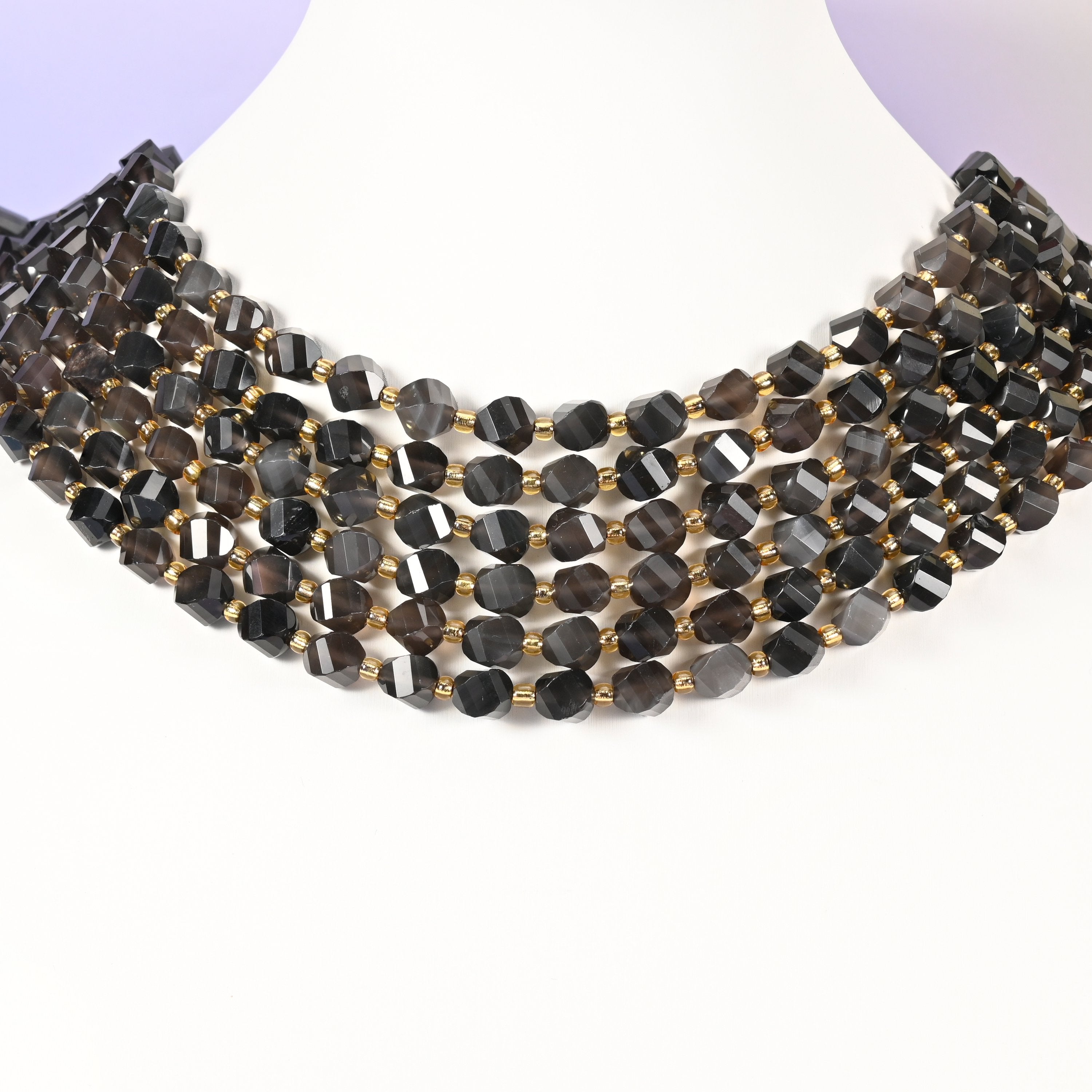 Ice obsidian natural stone beads showing grey and smoke banding inside the translucent 8mm faceted beads