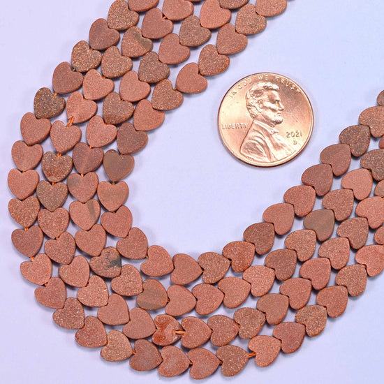 Flat heart cut gold sandstone beads