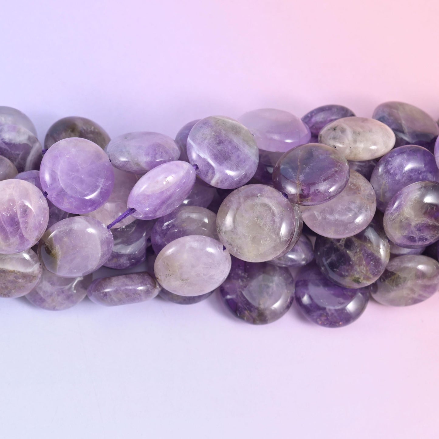 Macro side view of Amethyst coins showing flat faces and smoky patches