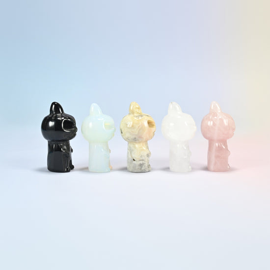Five pumpkin skull carvings at an angle in black obsidian, opalite, crazy agate, clear quartz and rose quartz