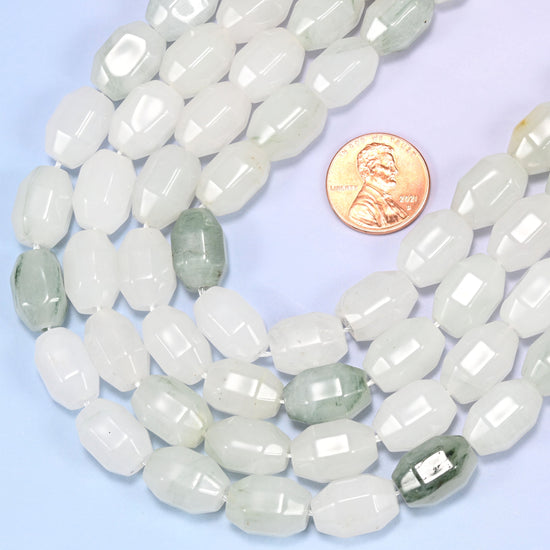 Circular coil of Tianshan Jade faceted barrel bead strands on a light background with a penny in the center for size comparison.