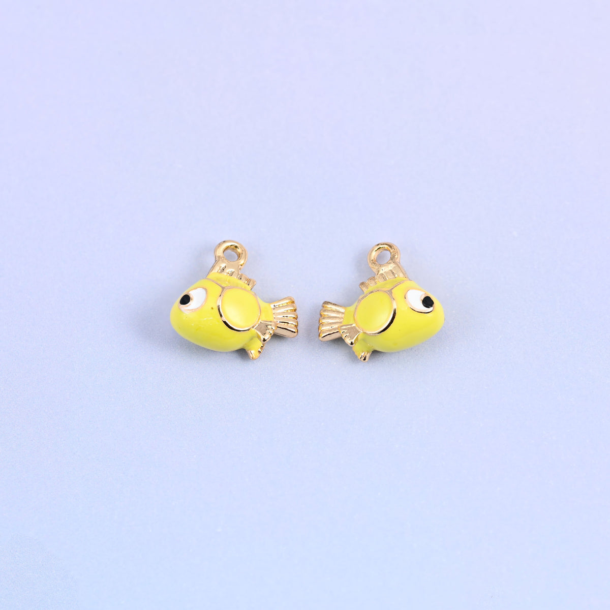 Fish charms front and back, the yellow green enamel sitting between yellow and green.