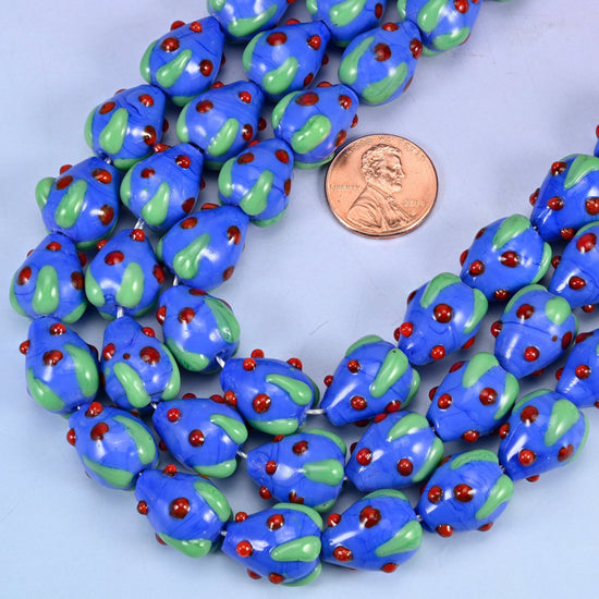 Strawberry shaped lampwork glass beads with raised red seed dots