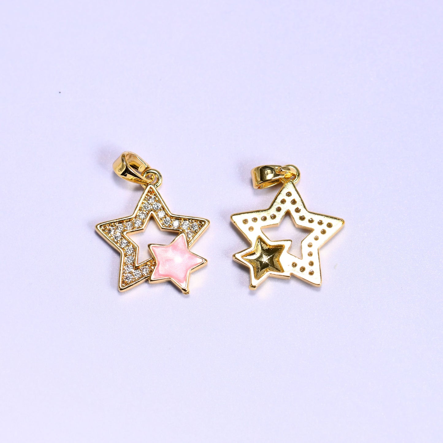 Front and back of the Double Stars Zirconia Charm, pink shell star with zirconia pave on the left and the dotted plain gold reverse on the right.