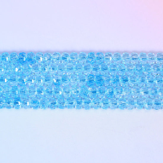 Transparent Blue Faceted Rondelle Glass Beads in a crisp aqua-blue tone