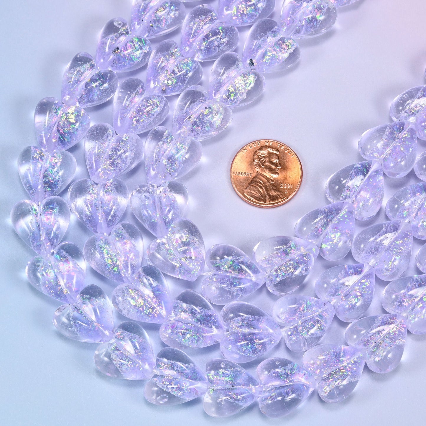 Transparent pale lilac glass heart beads with glittering iridescent shimmer