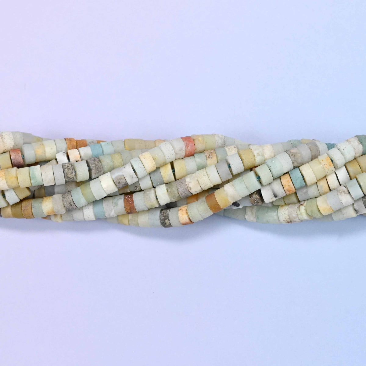 Natural multicolor amazonite matte heishi disc beads in a mix of soft cream, tan, gray and blue-green tones.