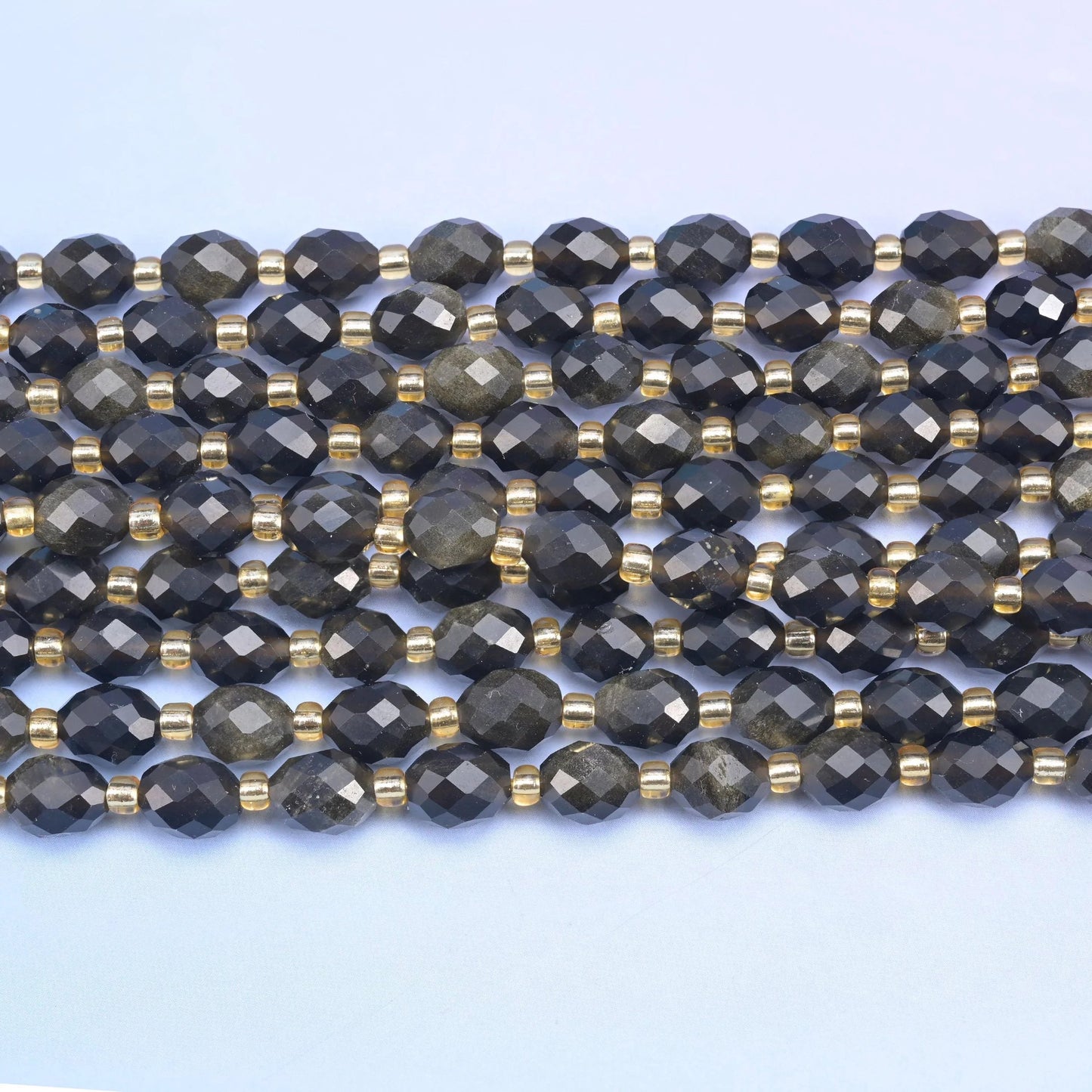 Faceted rice barrel cut gold obsidian beads