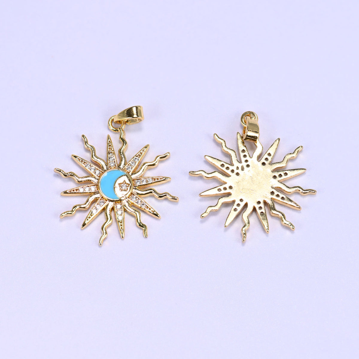 Blue enamel moon sun zirconia charm next to one flipped to its reverse, the gold sunburst rays left plain on the back.