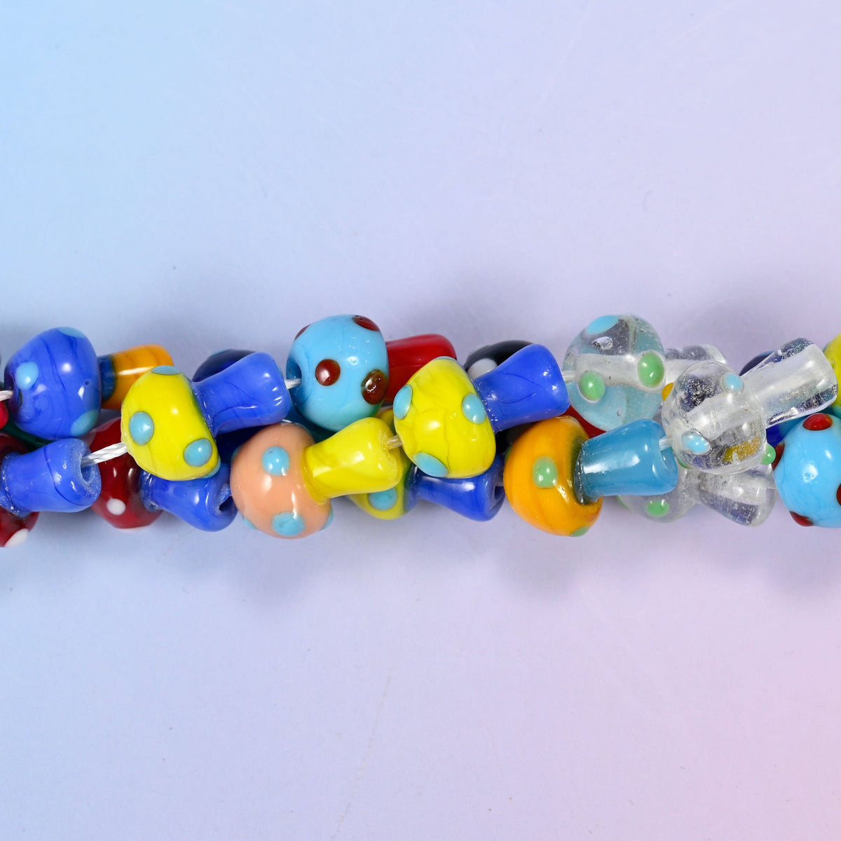 Mushroom-shaped lampwork glass beads with polka dot pattern