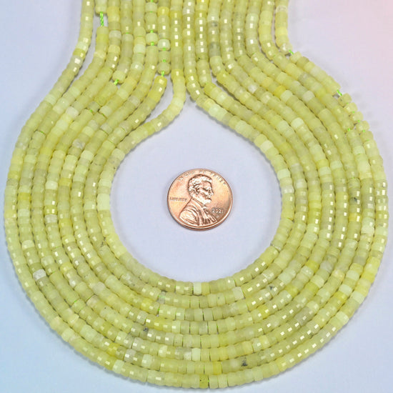 Lemon Jade faceted heishi disc strands formed into a teardrop loop around a US penny for scale