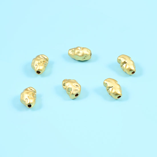 Solid gold filled nuggets with a soft brushed sheen and crumpled, organically dented outlines