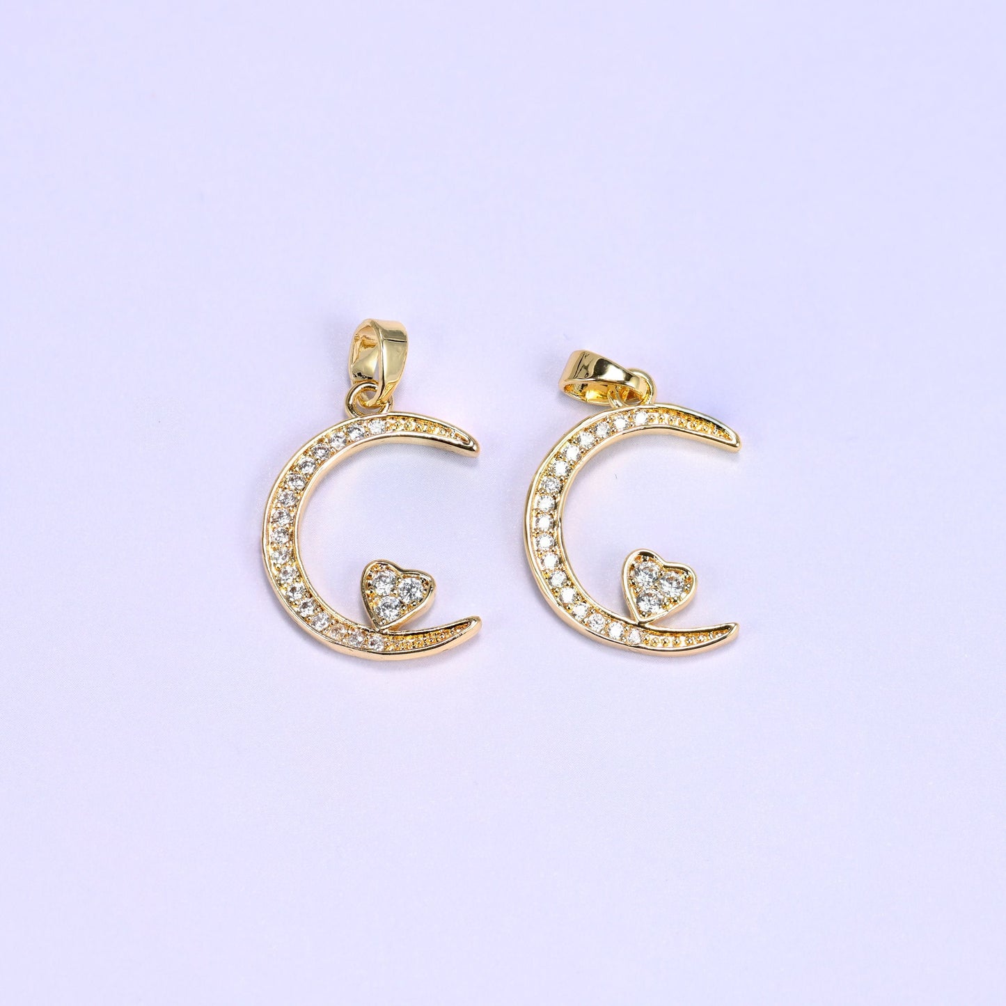 Crescent moon charm with a heart accent nestled in clear zircon pave