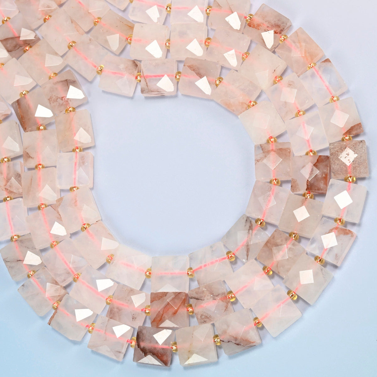 Natural red hematoid quartz faceted flat square beads curved into an open loop, light pink and frosted white beads with red-brown inclusions