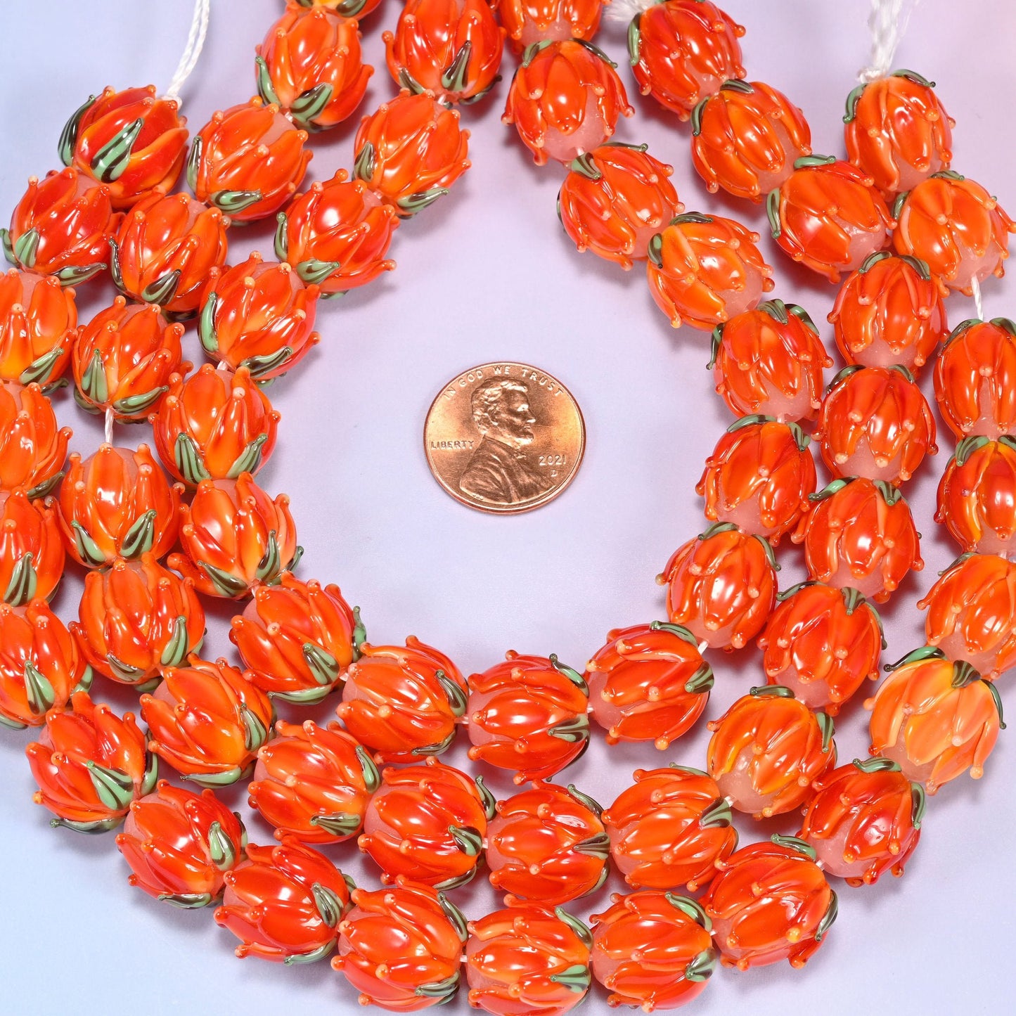 Orange tulip flower bud lampwork glass beads, approximately 20 beads per strand