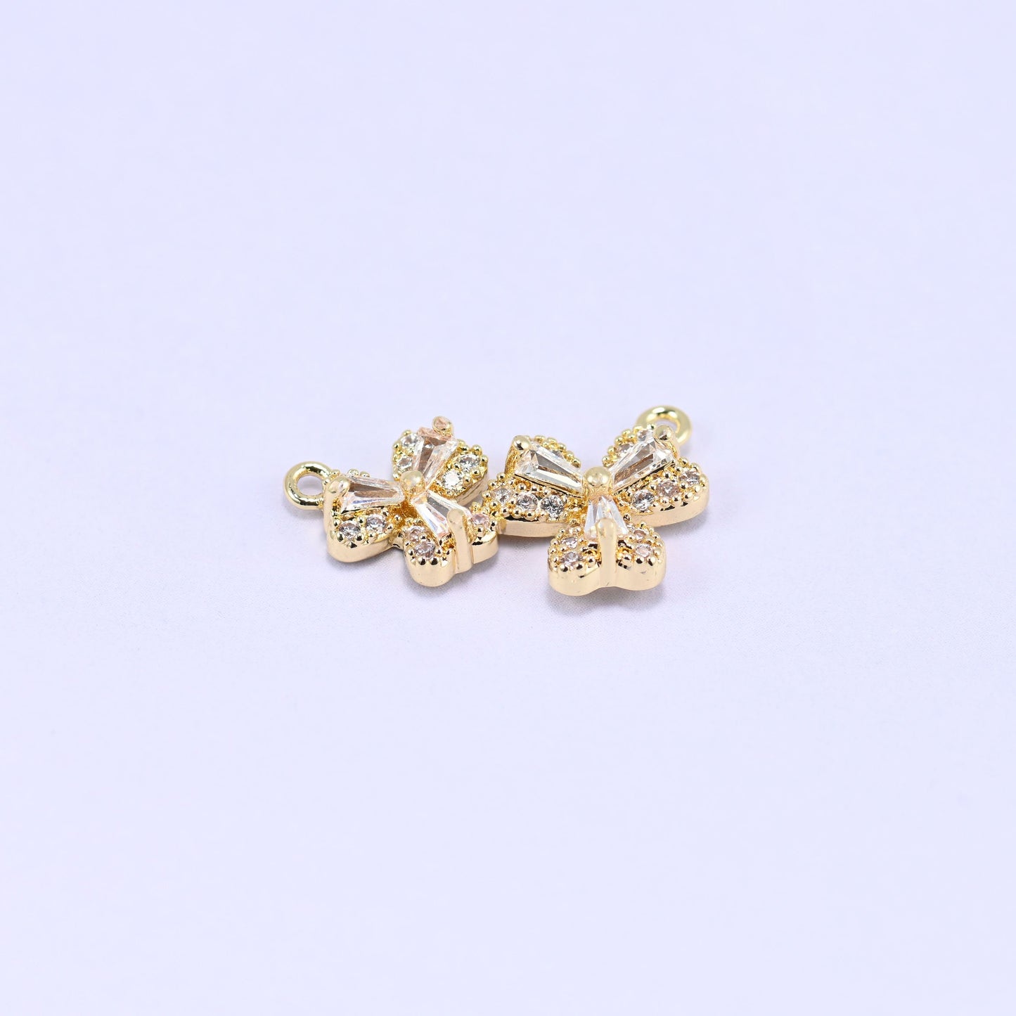 Three small blossoms pave set with clear zircon in a gently curved row