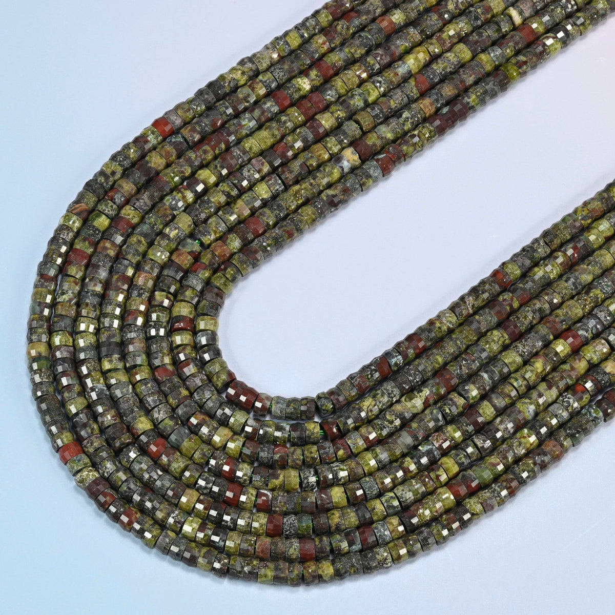 Dragon blood stone faceted heishi disc beads in several strands curved into a wide U, olive green stone with brick red patches