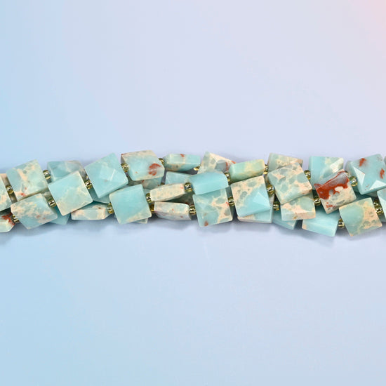 Strands of dyed blue Shoushan stone faceted flat square beads twisted together in a horizontal row