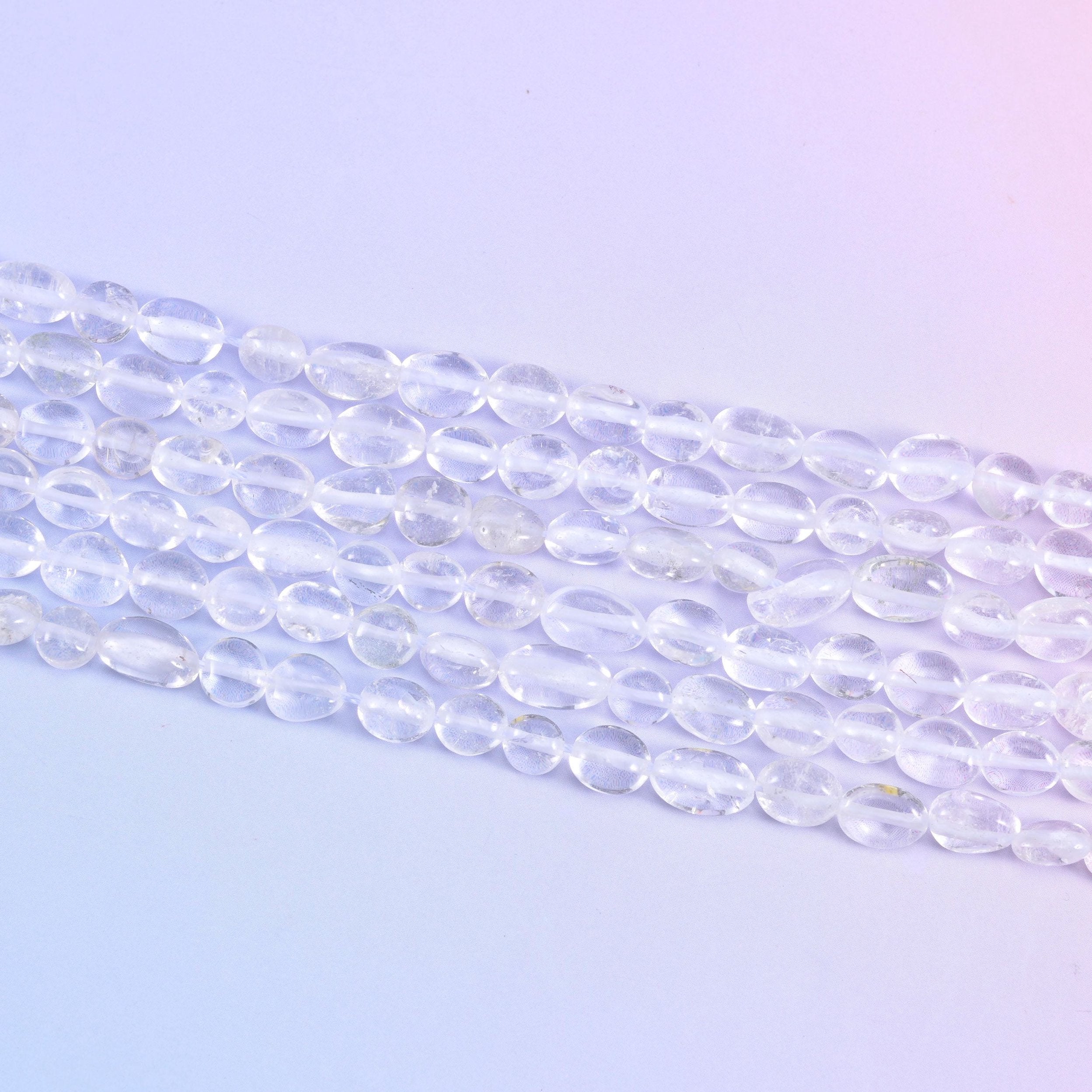 Strands laid flat, tumbled nuggets showing their varied lengths along each row