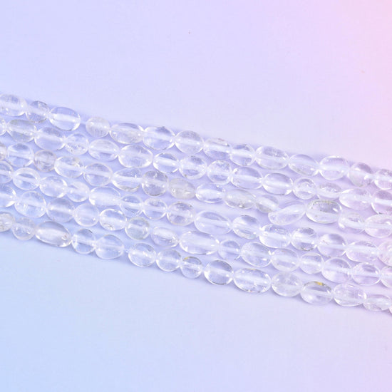 Strands laid flat, tumbled nuggets showing their varied lengths along each row