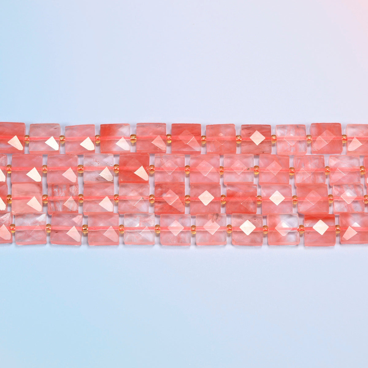 Several strands of melon quartz faceted flat square beads laid in straight rows