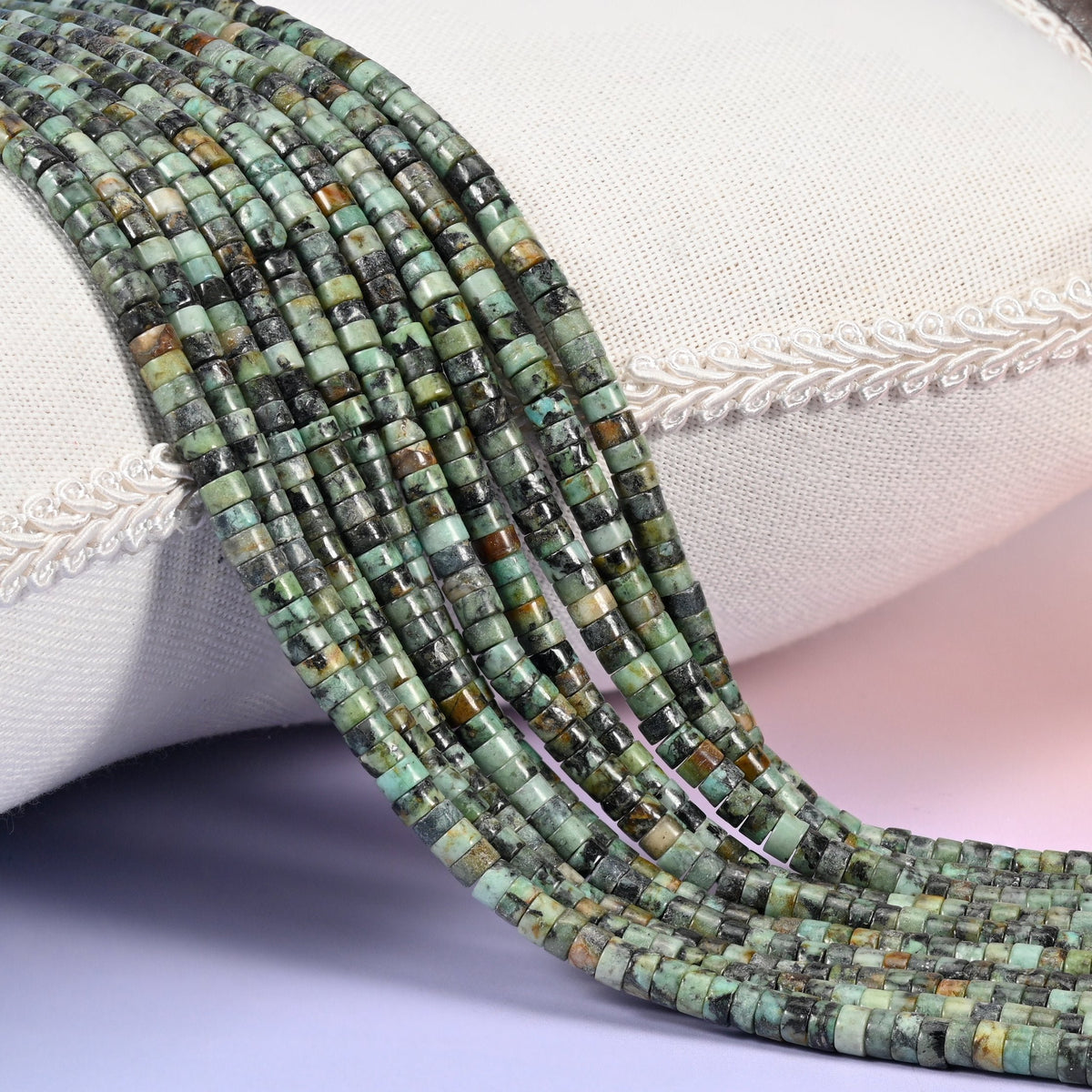 Natural African Howlite smooth heishi disc beads in mottled green with striking black matrix veining