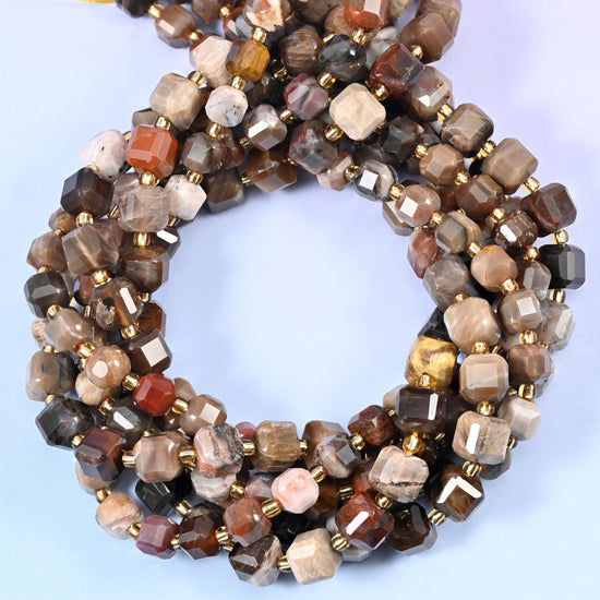 Warm chocolate, taupe, cream and rust cubes still carrying the grain and growth lines of the original wood, corner-faceted so the pattern breaks across several small planes.