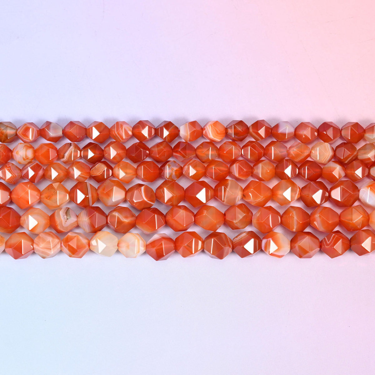 Dyed Red Stripe Agate faceted beads in flat horizontal rows, orange and white banding, sold per 15.5 inch strand