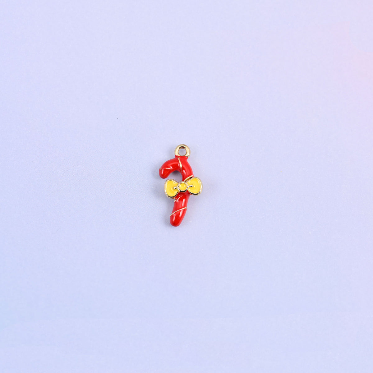 Single red candy cane charm with a gold spiral stripe and a yellow enamel bow at the crook.